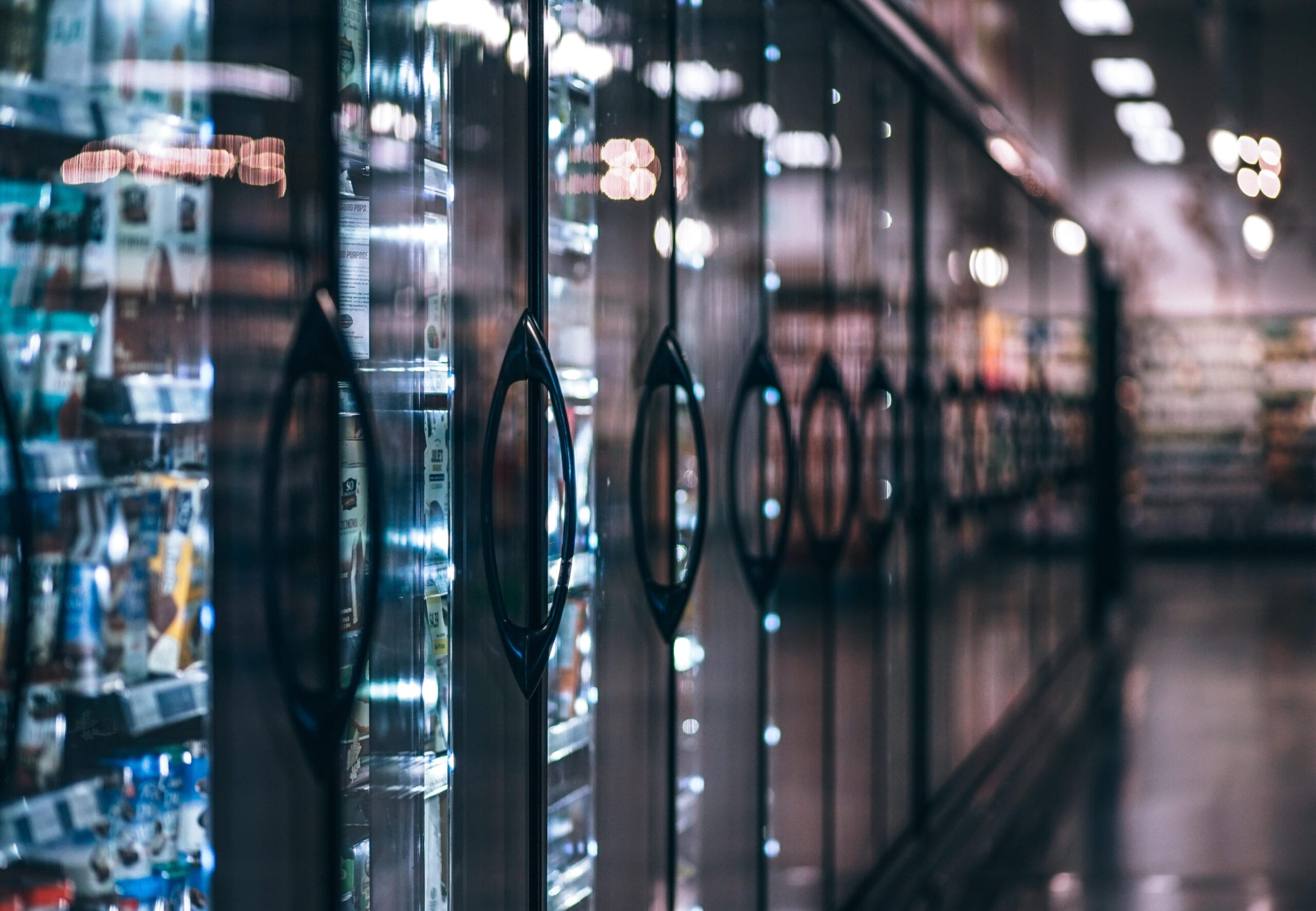 row of food coolers in grocery store